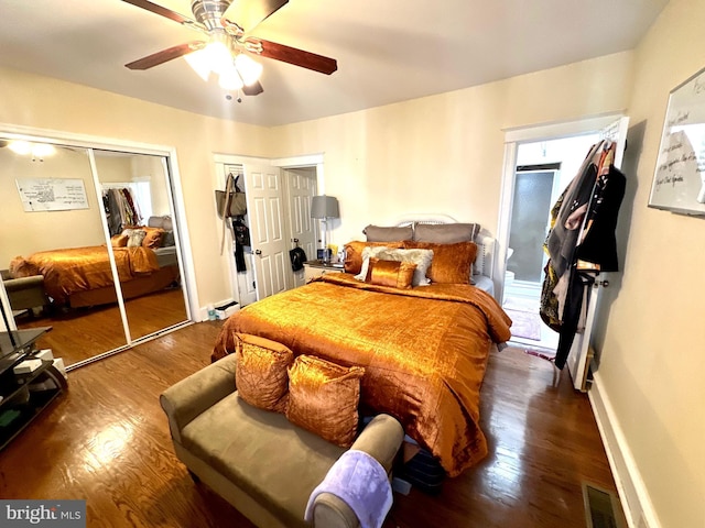 bedroom featuring multiple closets, ceiling fan, and dark hardwood / wood-style floors