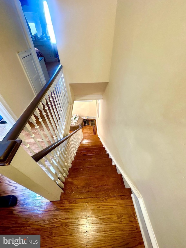 stairs featuring hardwood / wood-style flooring