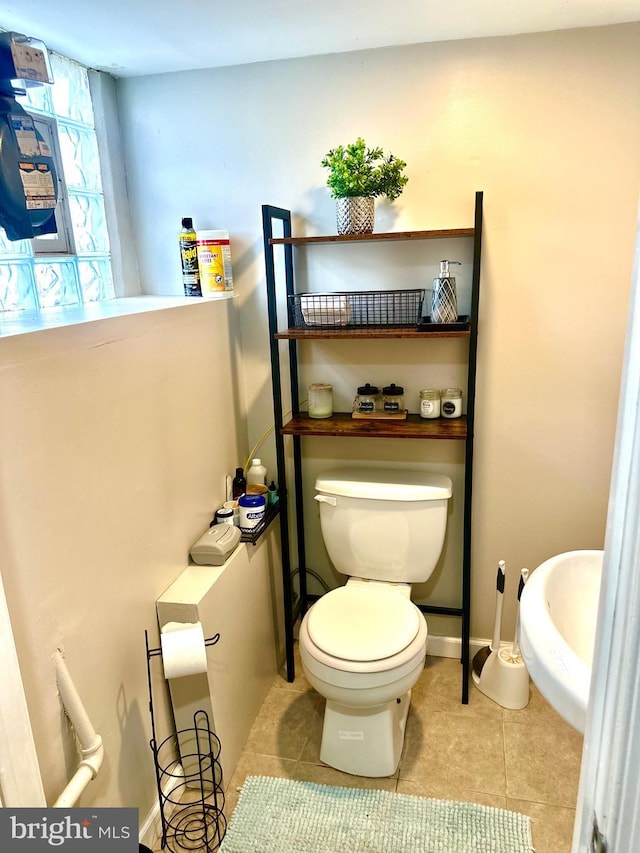 bathroom with tile patterned flooring and toilet