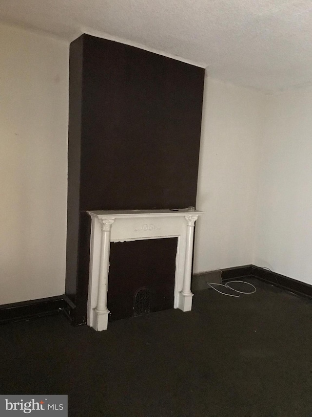 unfurnished living room with a textured ceiling