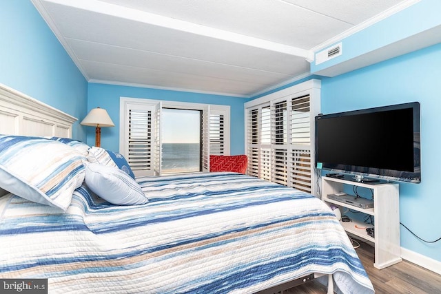 bedroom with hardwood / wood-style flooring and ornamental molding