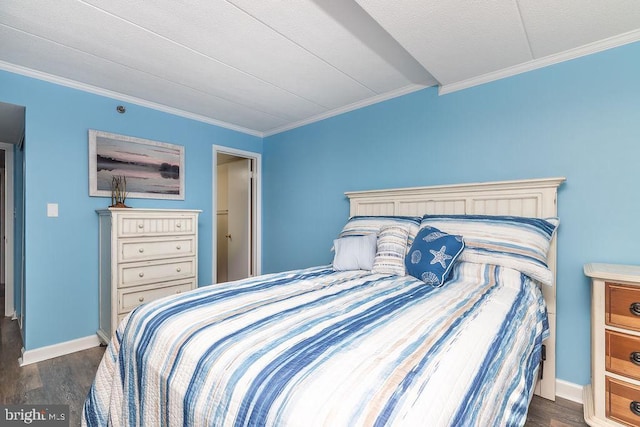 bedroom with dark hardwood / wood-style floors and crown molding