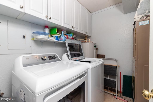 washroom featuring cabinets, electric panel, tile patterned flooring, washing machine and dryer, and water heater