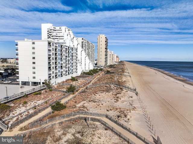 exterior space with a water view and a beach view