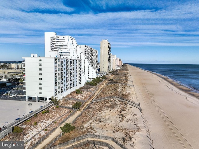 birds eye view of property featuring a beach view and a water view