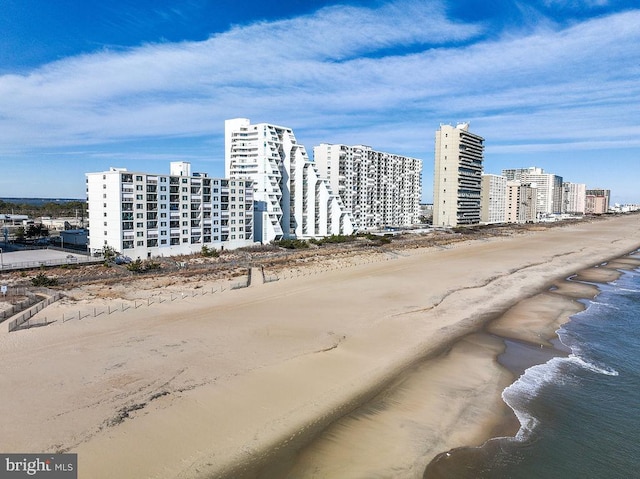 view of building exterior with a view of the beach and a water view