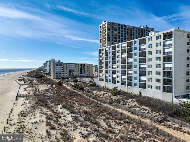 view of property featuring a water view and a beach view