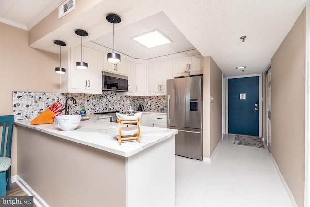 kitchen with white cabinets, decorative light fixtures, kitchen peninsula, and appliances with stainless steel finishes