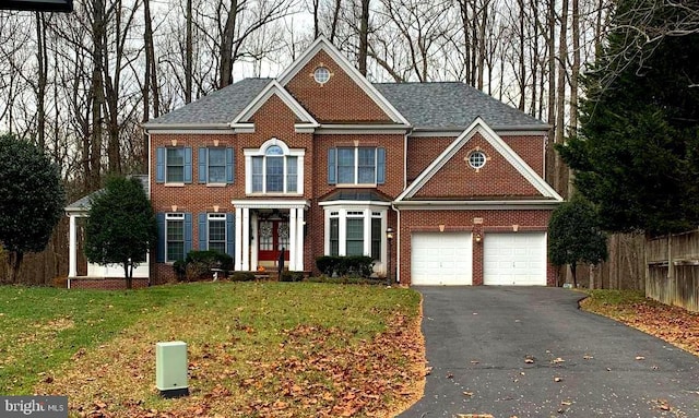 view of front of home with a garage and a front lawn