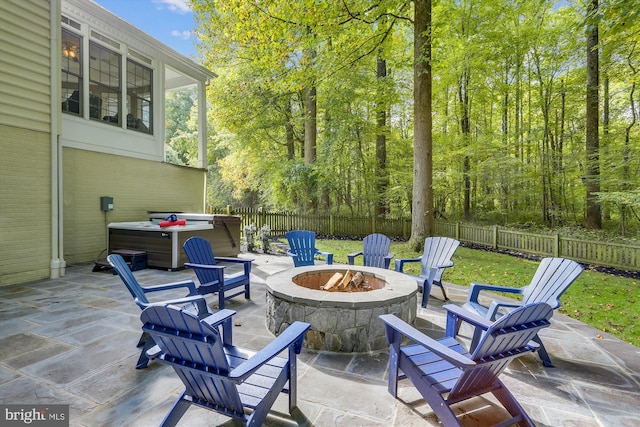 view of patio featuring a hot tub and a fire pit