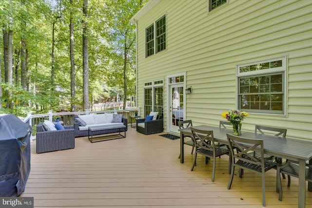 wooden terrace featuring grilling area and an outdoor hangout area