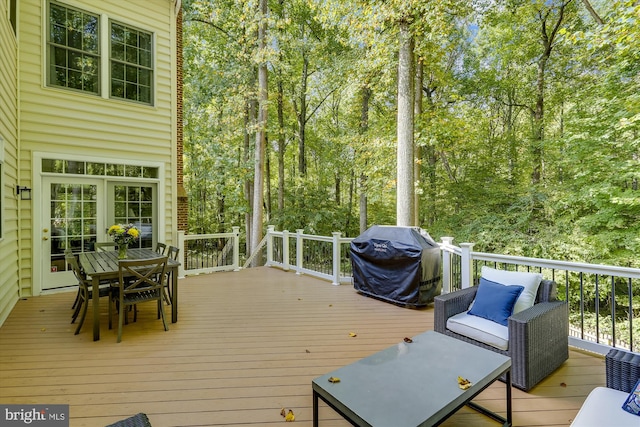 wooden deck featuring area for grilling