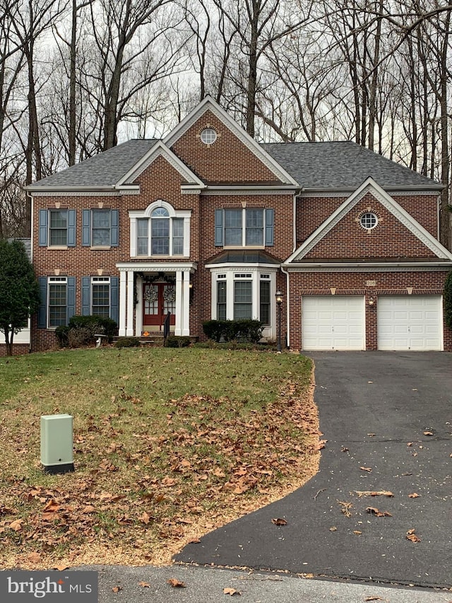 view of front facade featuring a garage and a front lawn