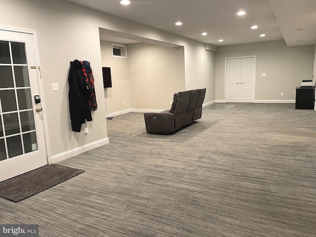 sitting room featuring dark colored carpet