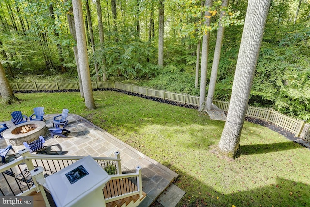 view of yard featuring a fire pit and a patio