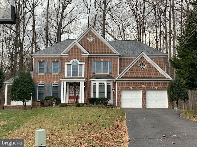 view of front of home featuring a front yard and a garage