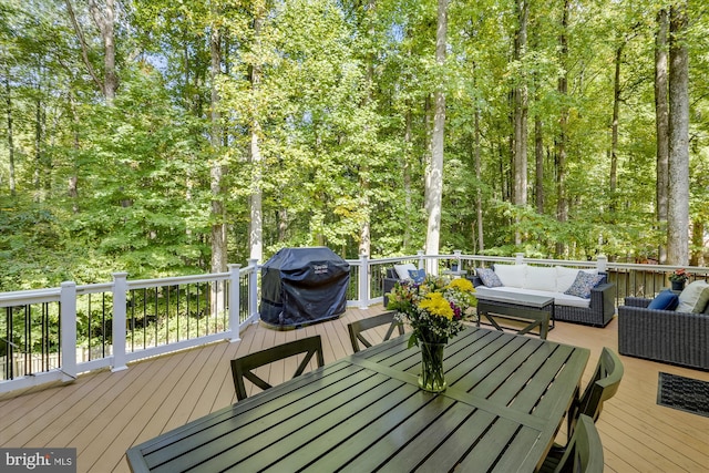 deck with area for grilling and outdoor lounge area