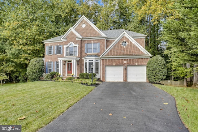 view of front of house featuring a garage and a front lawn