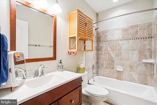 full bathroom featuring toilet, tiled shower / bath combo, and vanity