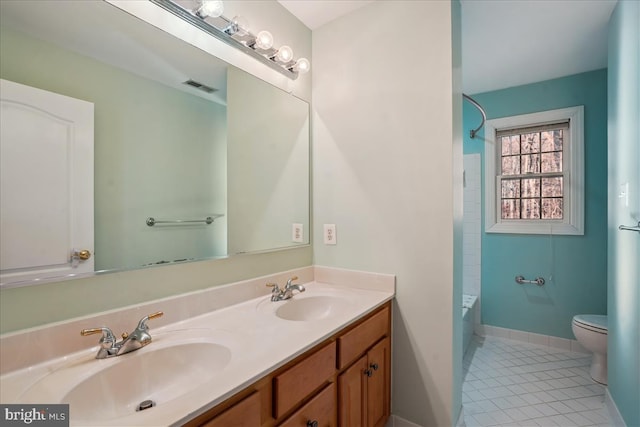 full bathroom with toilet, tile patterned flooring, vanity, and shower / tub combination