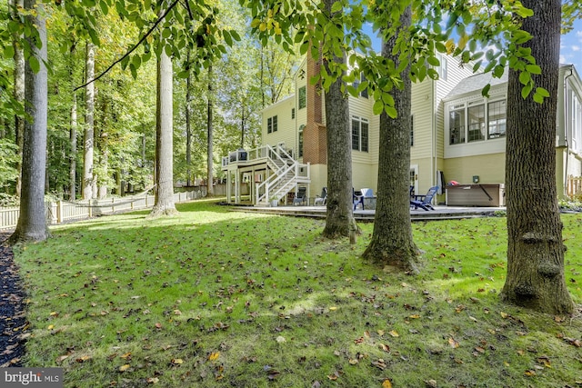 view of yard featuring a hot tub and a wooden deck