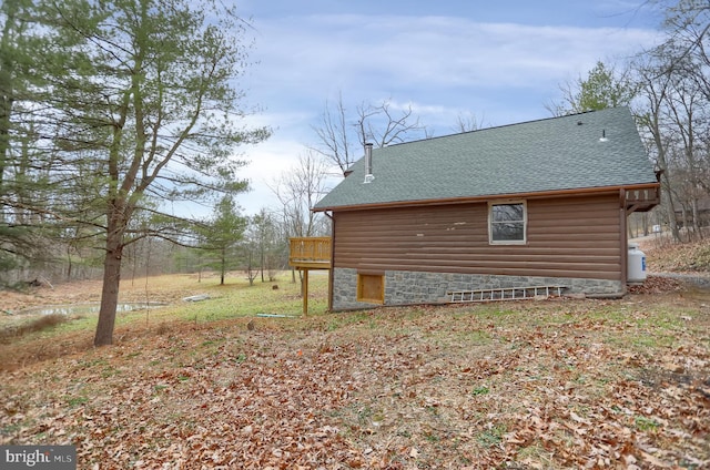 view of side of home featuring a wooden deck