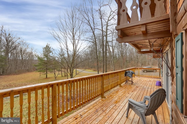 wooden terrace with a lawn