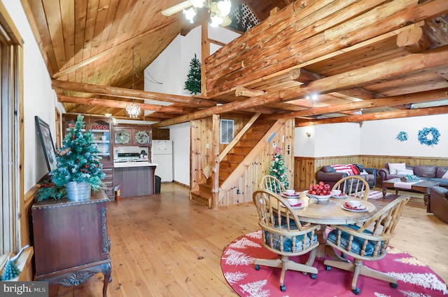 dining area featuring light hardwood / wood-style flooring, wooden walls, and wood ceiling