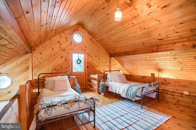 bedroom featuring lofted ceiling, light wood-type flooring, and wood ceiling