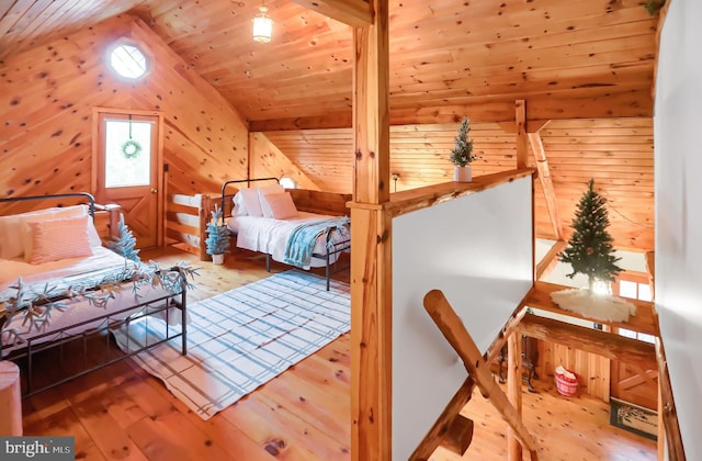 bedroom featuring wood-type flooring, vaulted ceiling, and wood ceiling