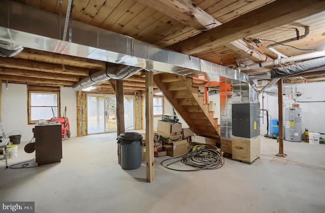 basement with electric water heater and heating unit