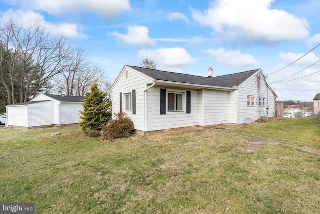 view of side of property with a lawn