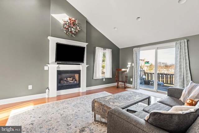 living room featuring hardwood / wood-style floors and high vaulted ceiling