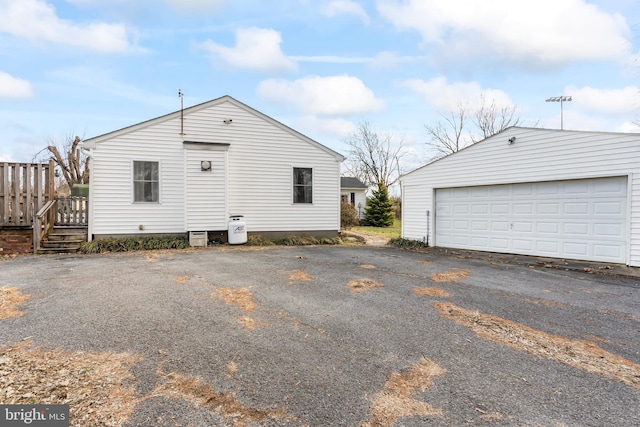 view of property exterior with a garage and a wooden deck