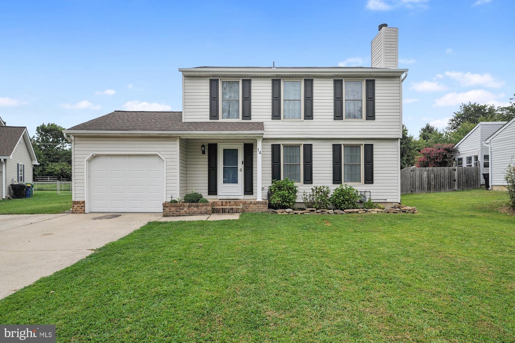 view of front of house with a garage and a front lawn