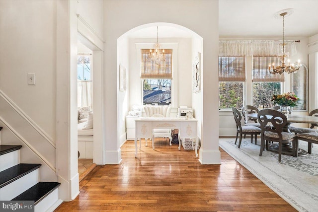 entrance foyer with hardwood / wood-style flooring and an inviting chandelier