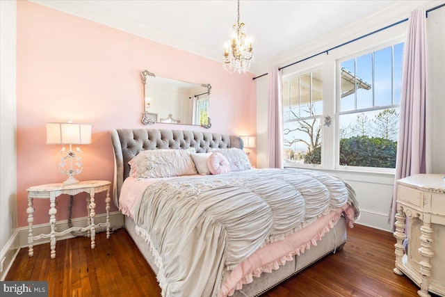 bedroom with dark hardwood / wood-style flooring, crown molding, and an inviting chandelier