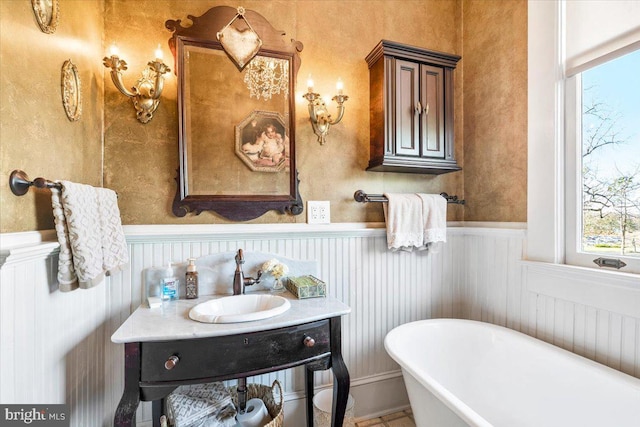 bathroom with a washtub and vanity