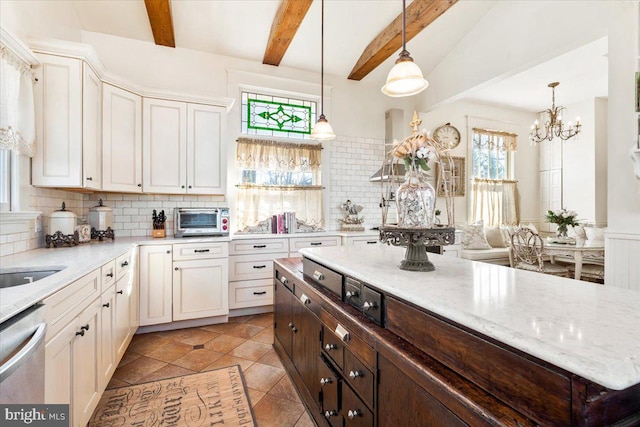 kitchen featuring stainless steel dishwasher, dark brown cabinetry, an inviting chandelier, beamed ceiling, and hanging light fixtures