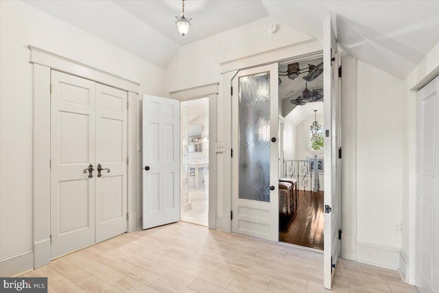 interior space featuring light wood-type flooring and lofted ceiling