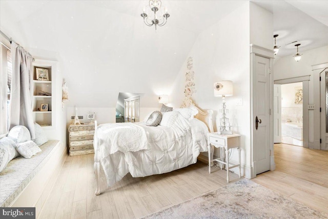 bedroom with light hardwood / wood-style flooring and lofted ceiling