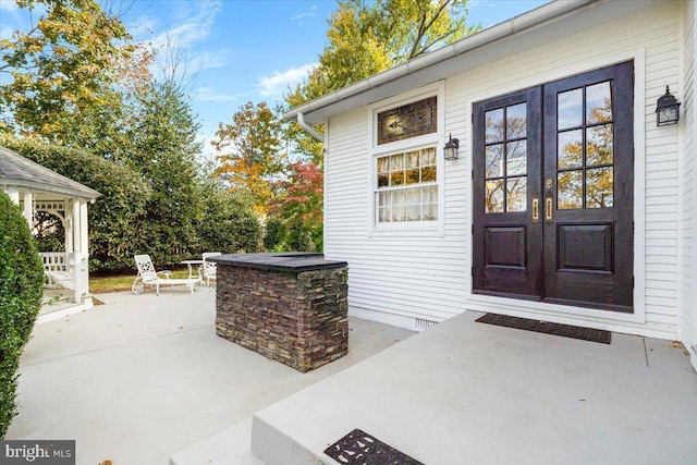 property entrance featuring french doors and a patio