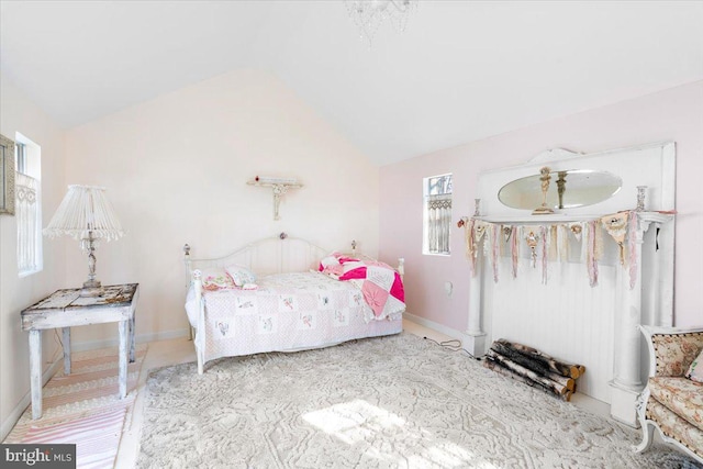 bedroom featuring multiple windows and vaulted ceiling