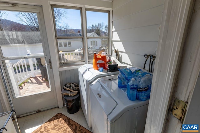 clothes washing area featuring washer and clothes dryer and a wealth of natural light