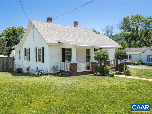 view of front facade featuring covered porch, central AC, and a front yard