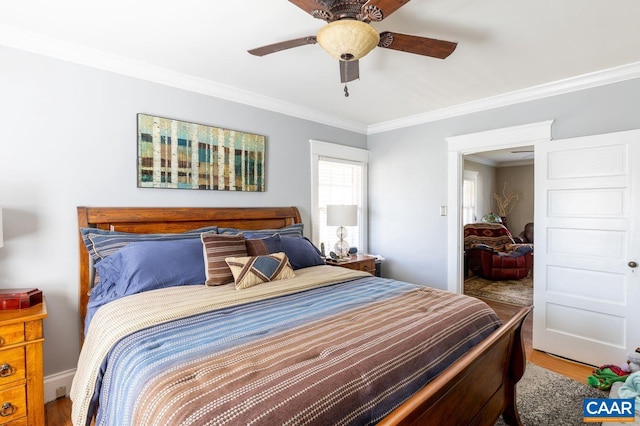 bedroom featuring ceiling fan, wood-type flooring, and crown molding