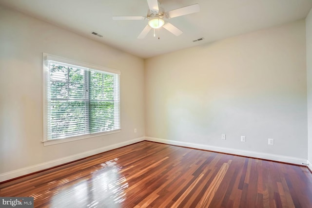 empty room featuring ceiling fan and dark hardwood / wood-style flooring