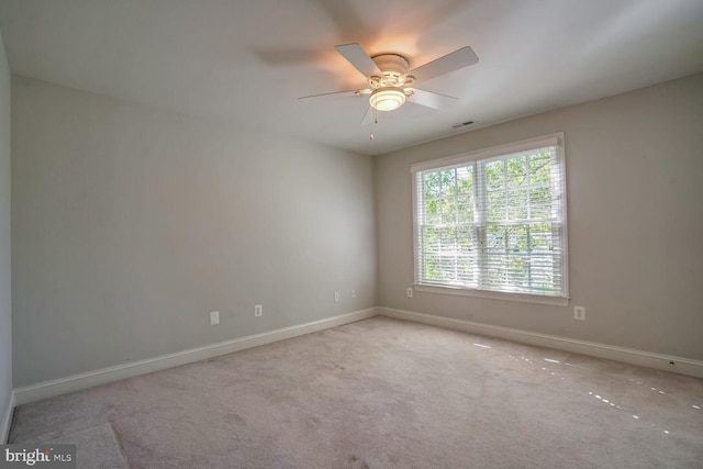 unfurnished room with light carpet and ceiling fan