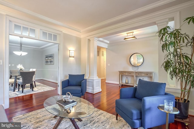 living room featuring decorative columns, crown molding, and dark hardwood / wood-style flooring