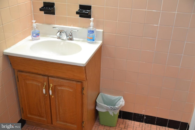 bathroom with vanity and tile walls